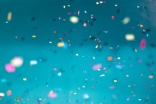 Confetties exploding on a blue background
